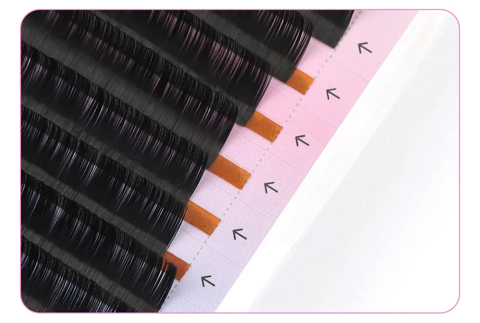 Black silk Russian volume eyelash extension strips on a pink tray with indicator arrows.