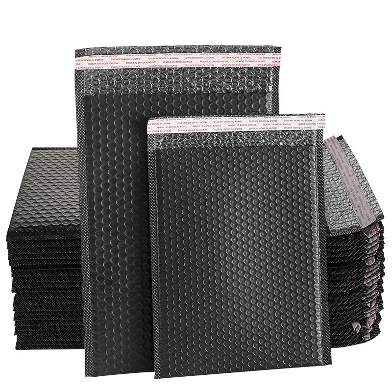 Waterproof black bubble mailer envelope stack with self-seal strip and raised protective bubbles