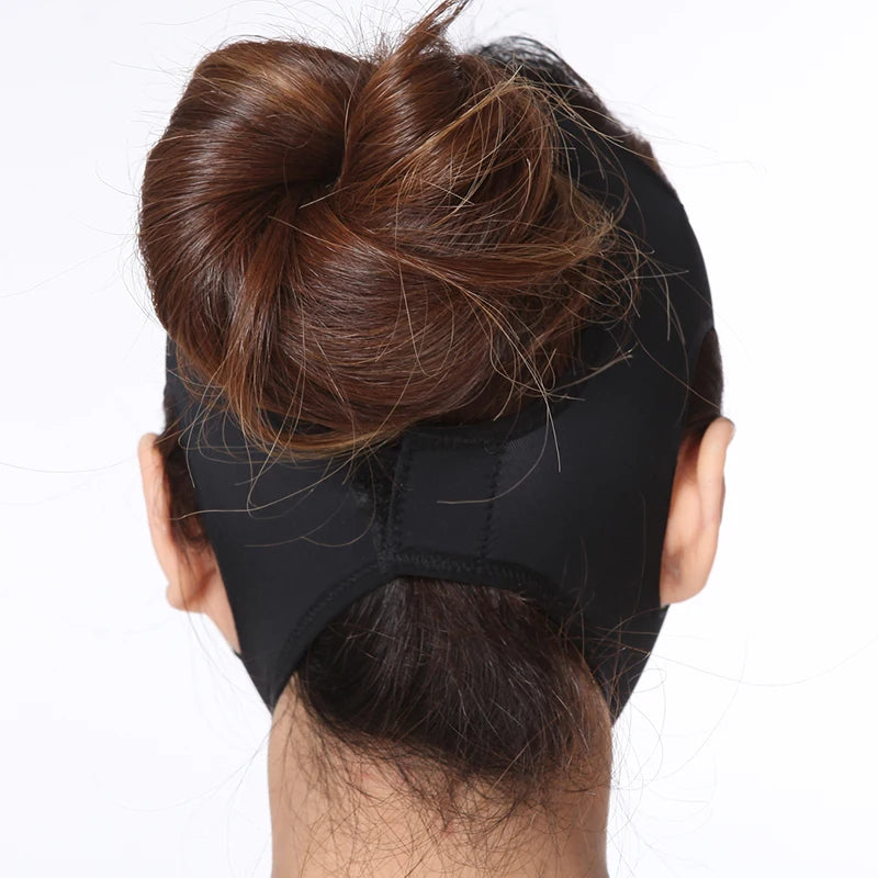 A woman wearing a black elastic V-line face slimming bandage strap that wraps around the chin and head.