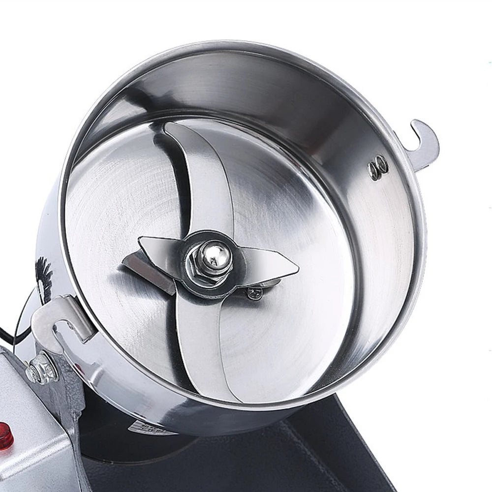 Stainless steel commercial spice and coffee grinder with sharp interior blades for heavy-duty grinding.
