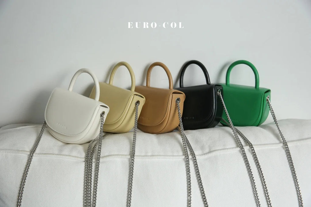 Small designer cowhide leather evening clutch bags with top handles, chain straps, and flap closures in five colors.