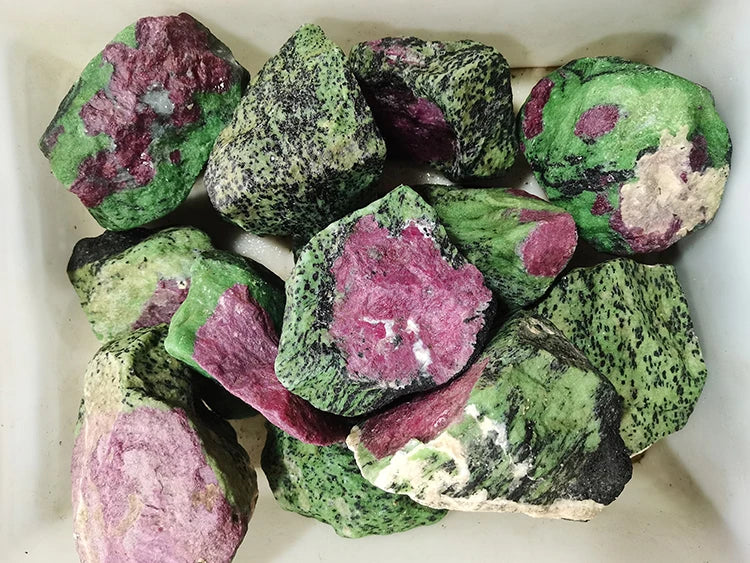 Assorted rough red and green quartz stones, natural raw rock pieces