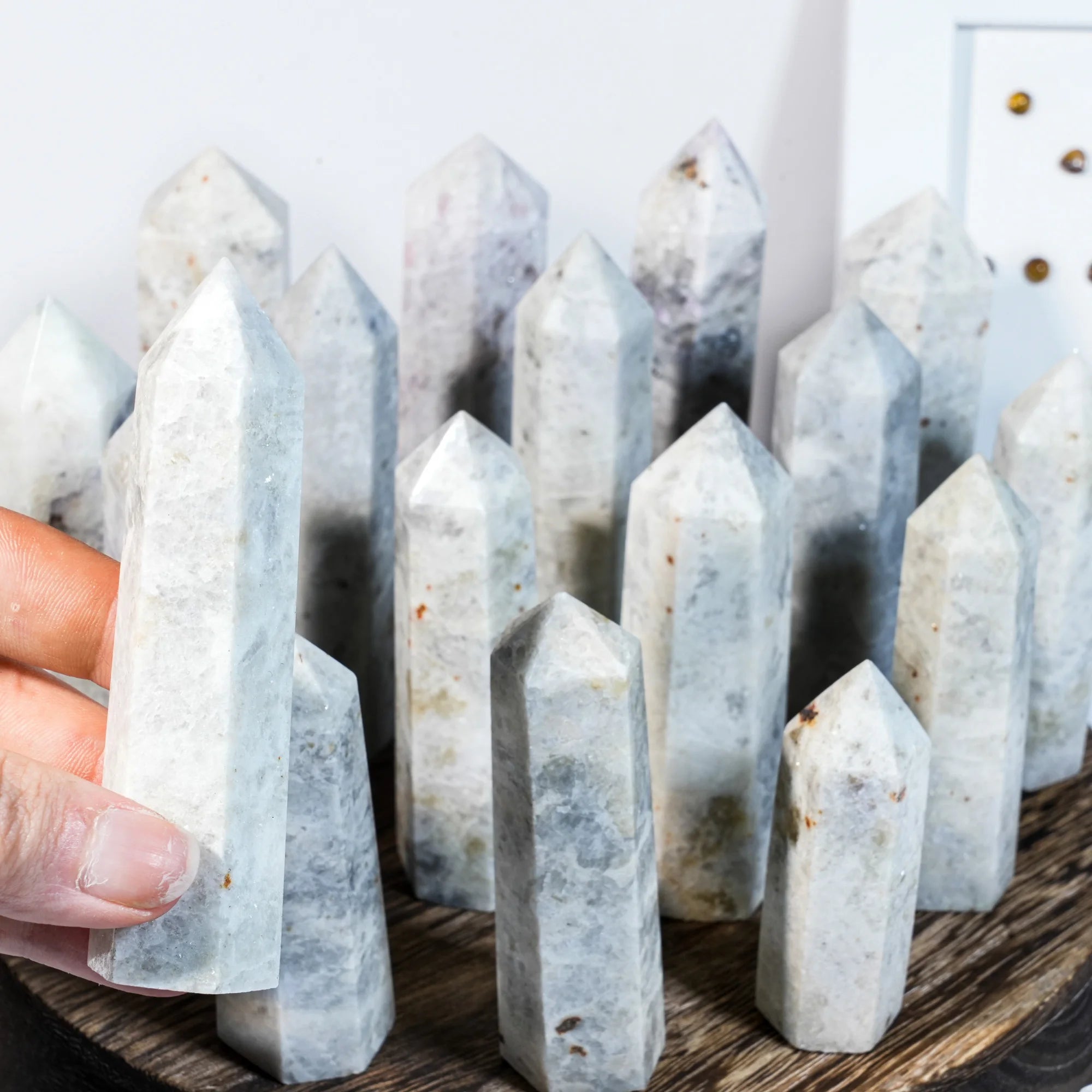 Natural gemstone crystal point tower with pointed stones, one tower held by hand.