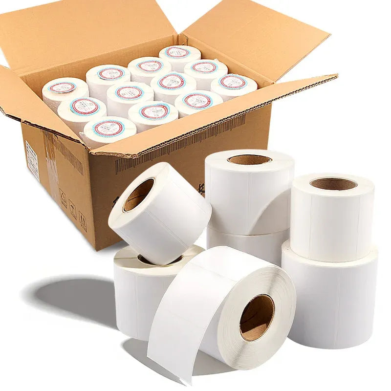 White glossy self-adhesive label rolls with blank label strips in open cardboard box