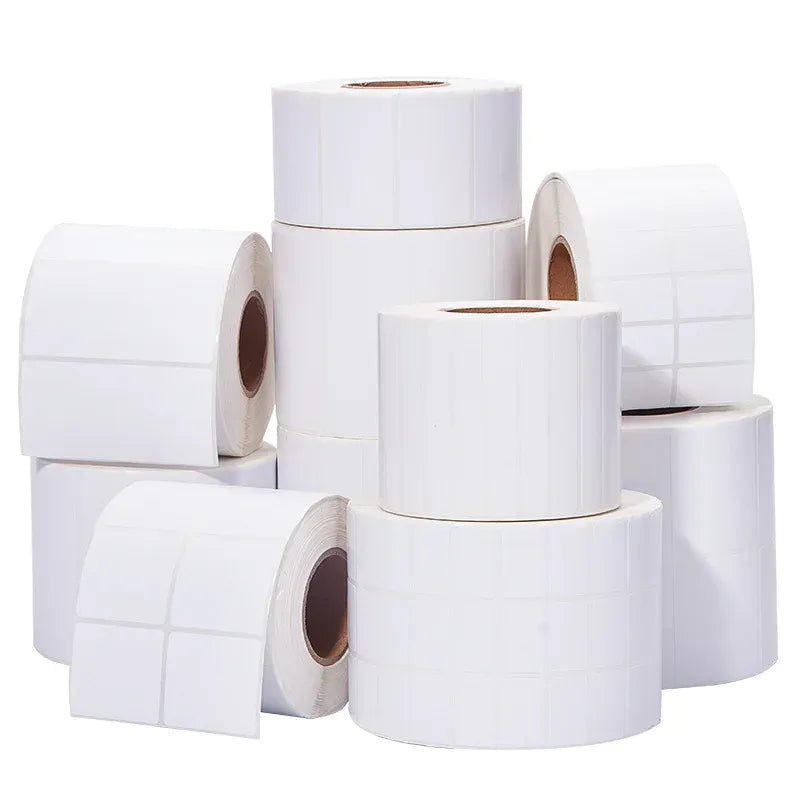 Set of white blank label rolls with brown cores, stacked in a bundle.