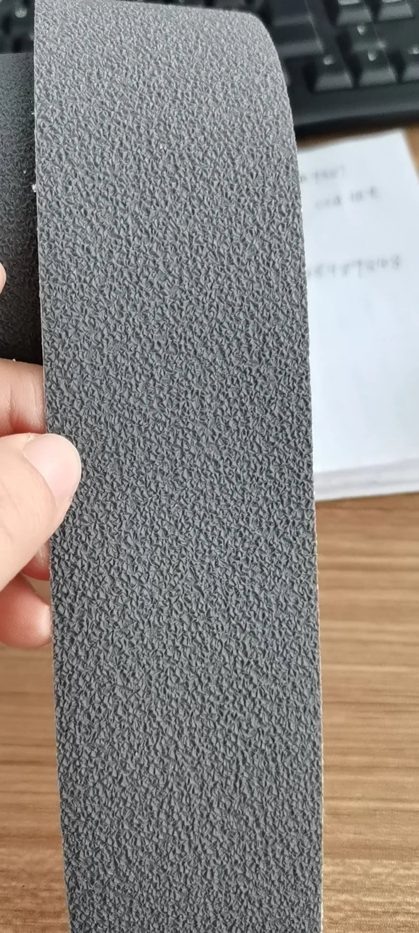 Black textured anti-slip tape strip roll, dense coarse surface for grip