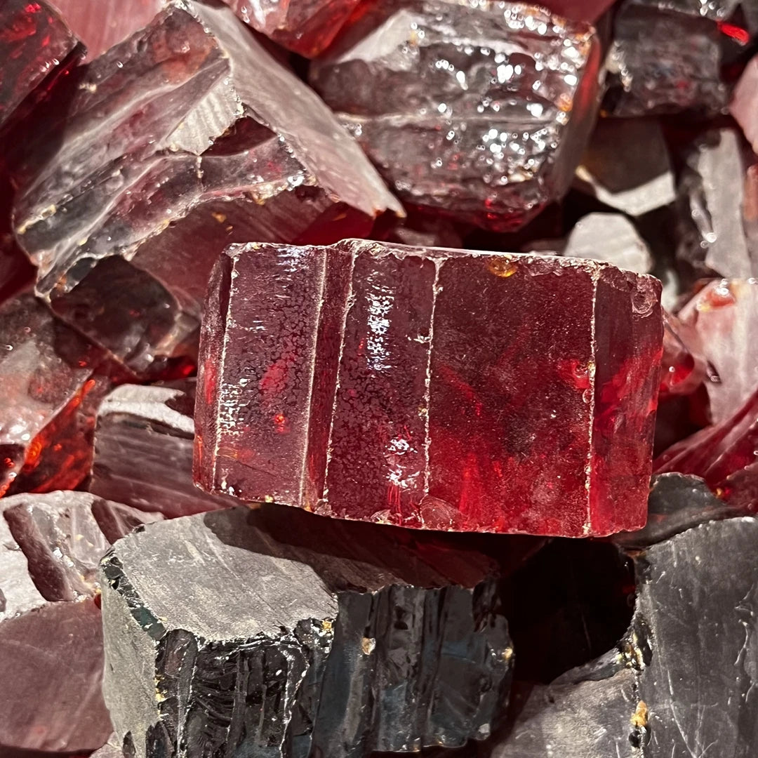 Loose cubic zirconia rough pieces, red and clear uncut facets in pile