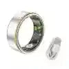 Silver smart ring with electronic sensors on the inner band, accompanied by a small plastic charging adapter.