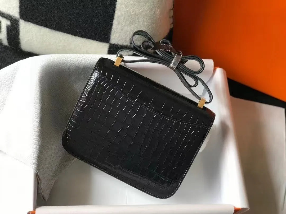 Black genuine leather women's shoulder bag with alligator pattern, compact flight attendant style, and gold hardware.