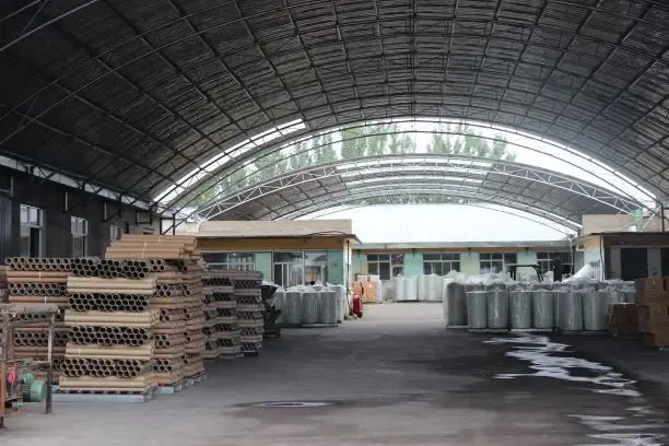 White masking tape rolls stacked on pallets in a factory warehouse