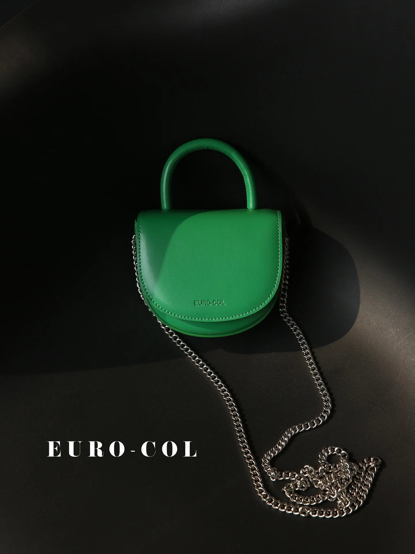 Green cowhide leather mini evening clutch with top handle and silver chain strap for weddings or parties.