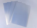 Silver-toned printable sticker vinyl sheets stacked, matte finish, ready for use.