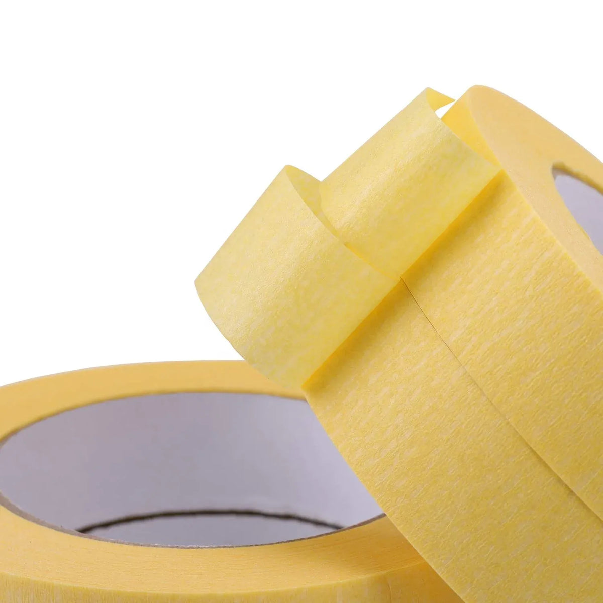 Close-up of yellow masking tape rolls with layered edges and paper backing