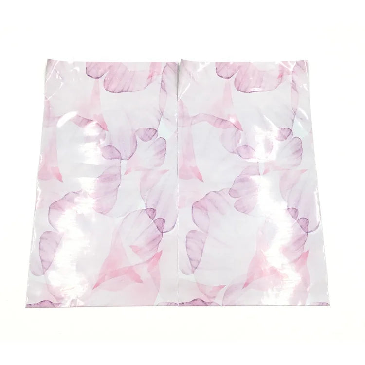 Pink translucent poly mailer bag front with large pastel floral pattern