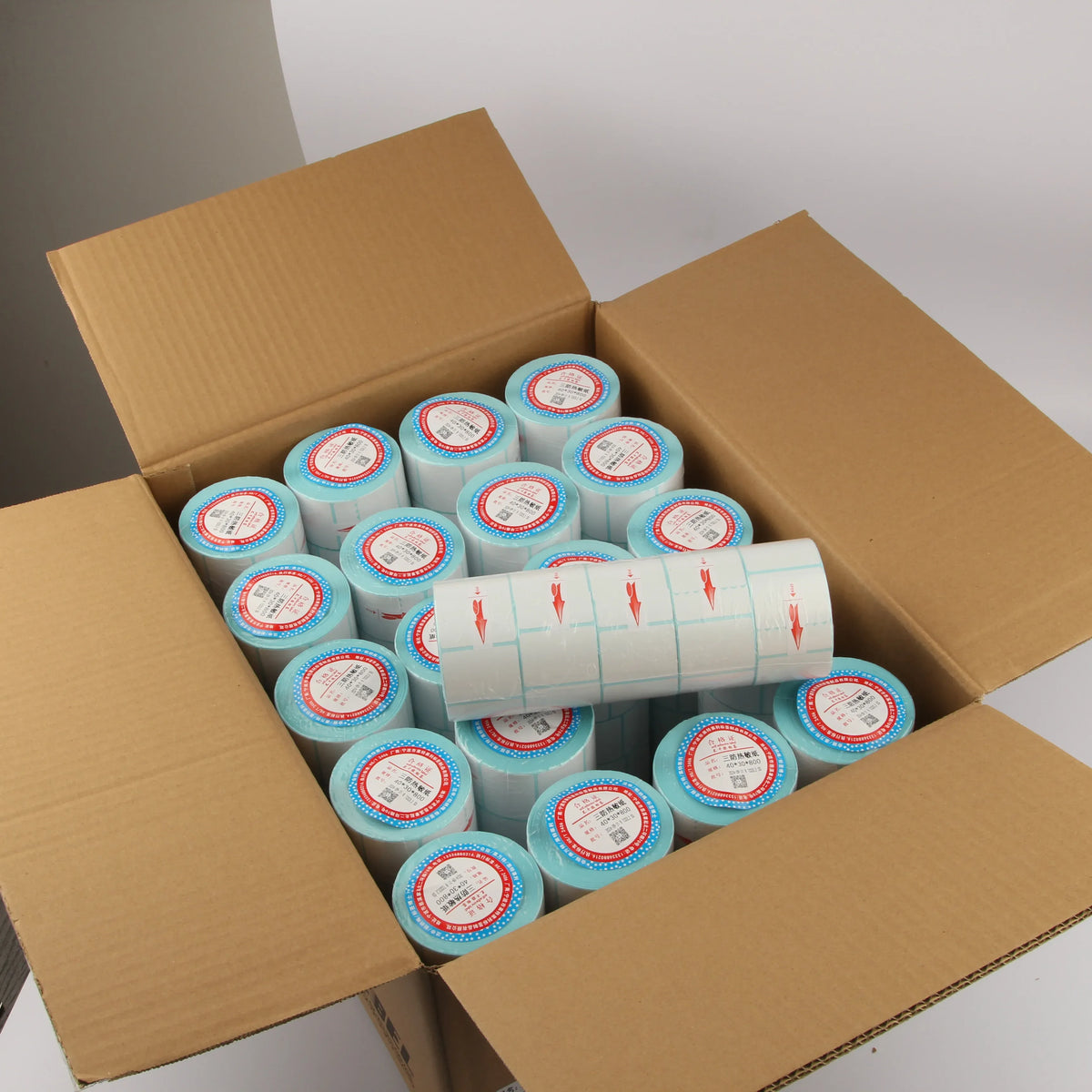 Sky blue and white direct thermal label rolls packed in a shipping box