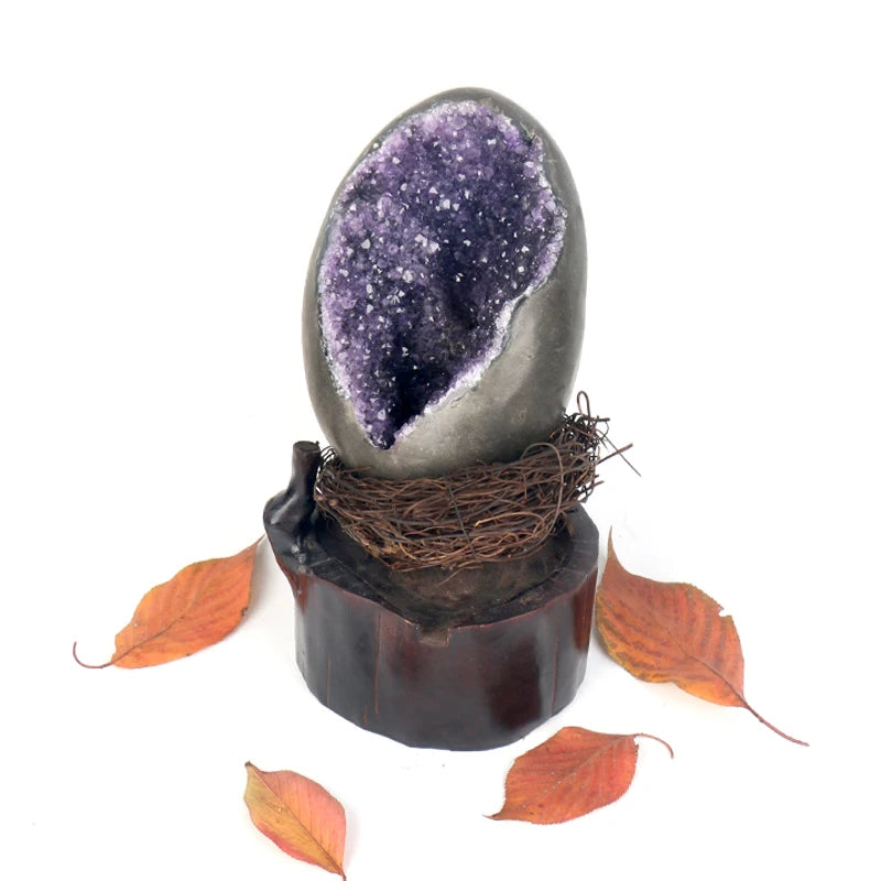 Amethyst crystal geode egg on dark base wrapped with twine, purple geode center