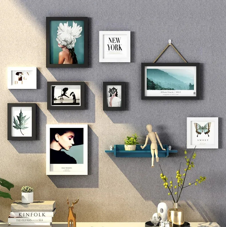 Multiple photo frames mounted on a wall using adhesive tape
