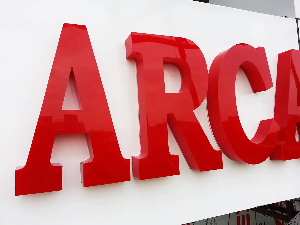 Red adhesive tape shaped into large letter forms on a white board