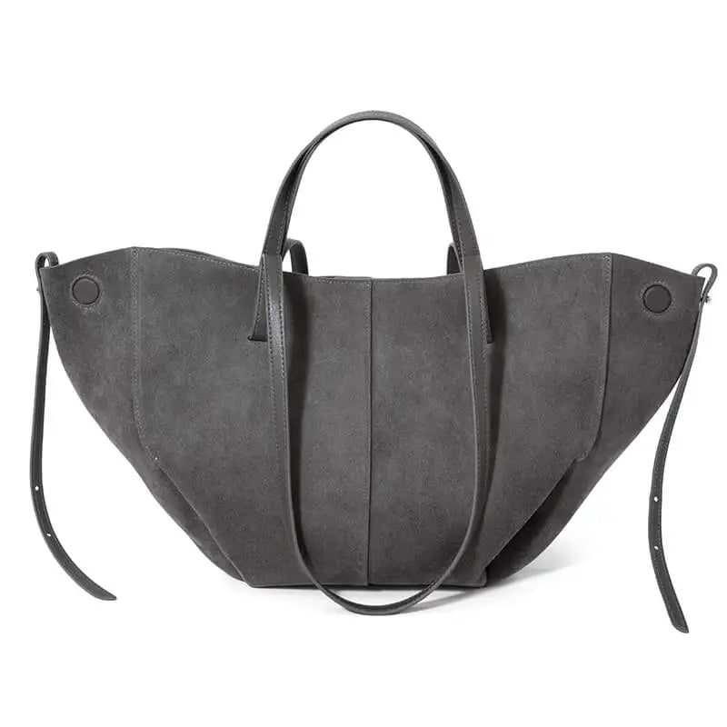 Grey genuine suede designer handbag with a slouchy, wide-wing silhouette and long leather handles.