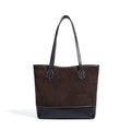 Dark brown suede underarm tote bag with black textured leather base, minimalist vintage style, and stitched handles.