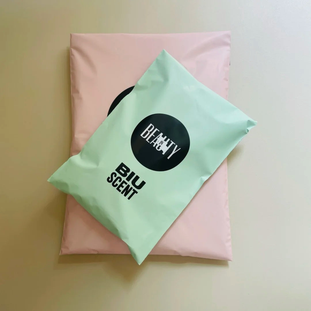 Pink and mint poly mailer shipping bag with printed circular logo