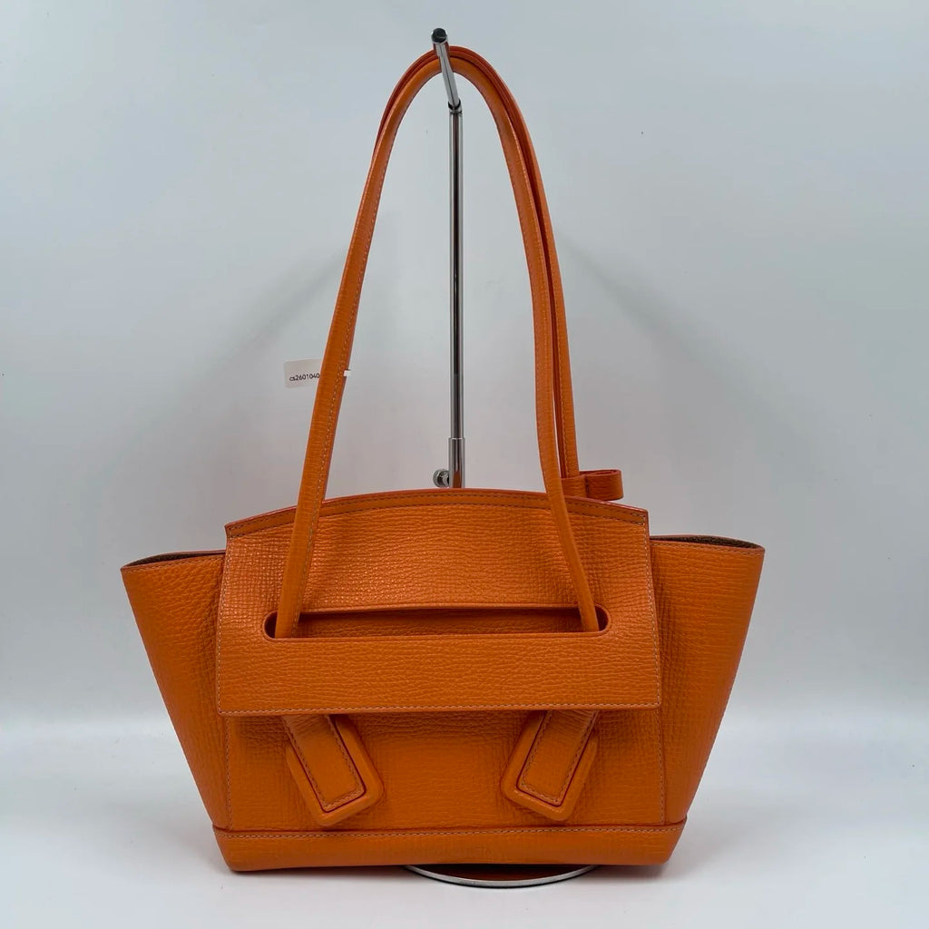 Orange genuine leather designer shoulder tote bag with double handles and a structured front flap closure.