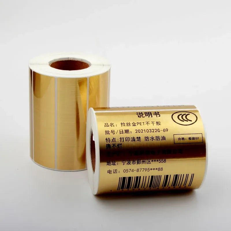 Gold adhesive PET label roll with printed barcode label on white backing