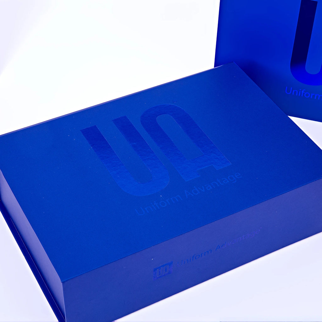 Blue corrugated mailer box with custom logo on lid, close-up view from above.