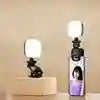 Small square LED clip-on fill lights for smartphones, featuring black plastic housings for improved lighting in photos.