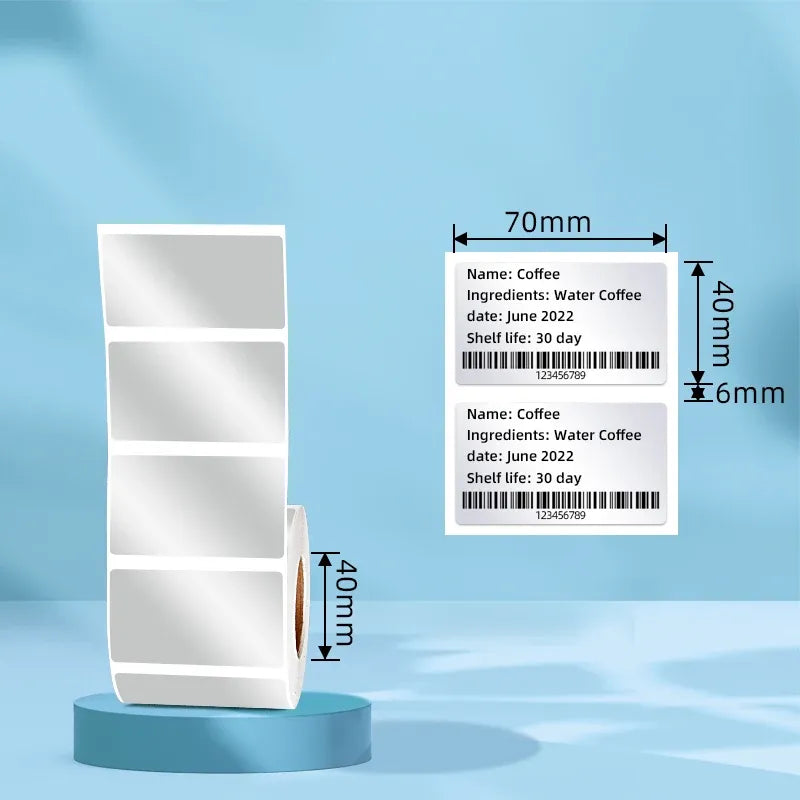 Silver thermal label sheets on display stand, showing 70mm x 40mm size and barcode