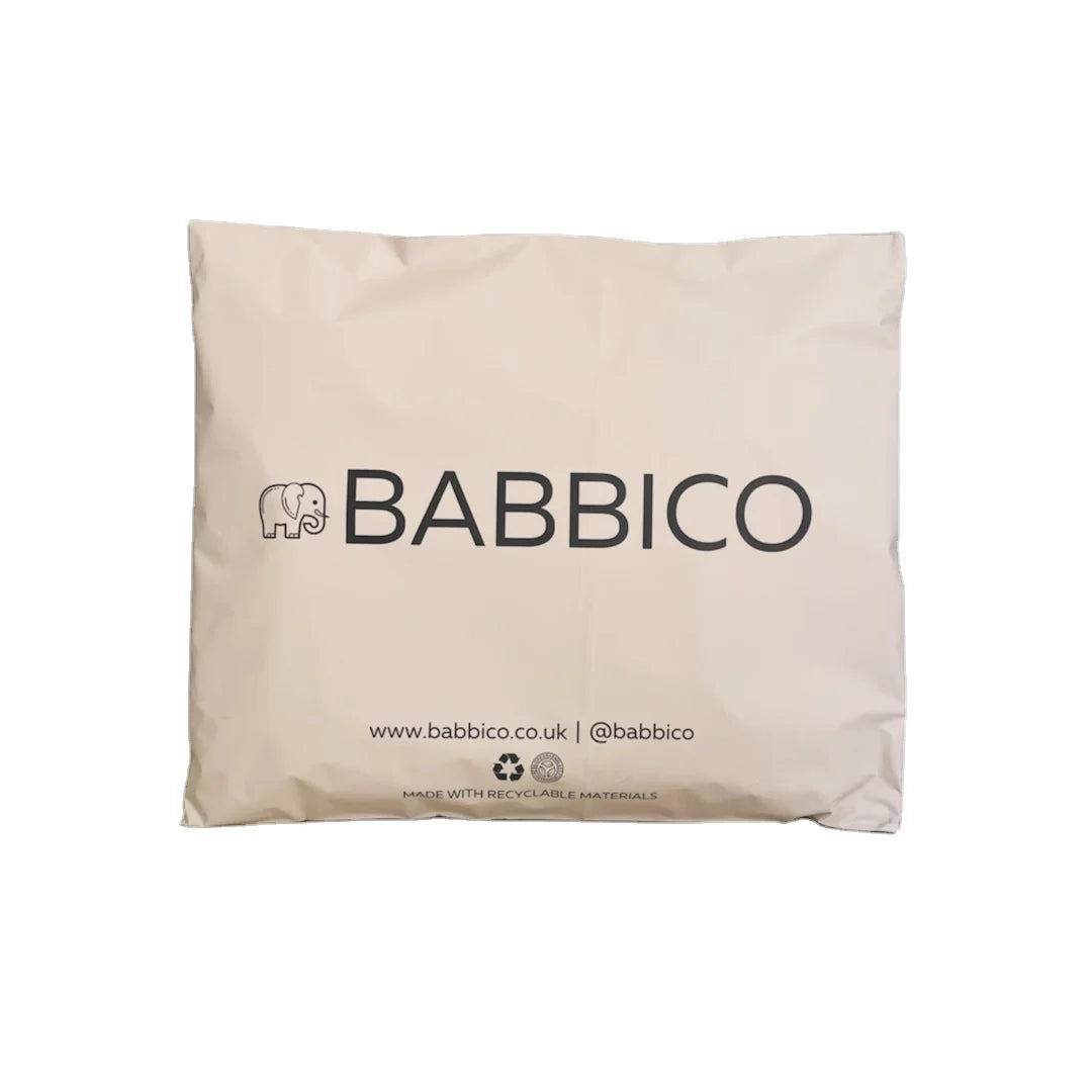 Beige poly mailer bag with “BABBI CO” logo and website text at the bottom.