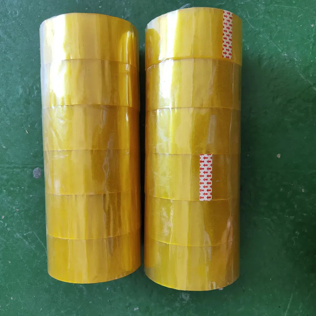 Yellow water-activated BOPP packing tape rolls stacked, glossy transparent tape