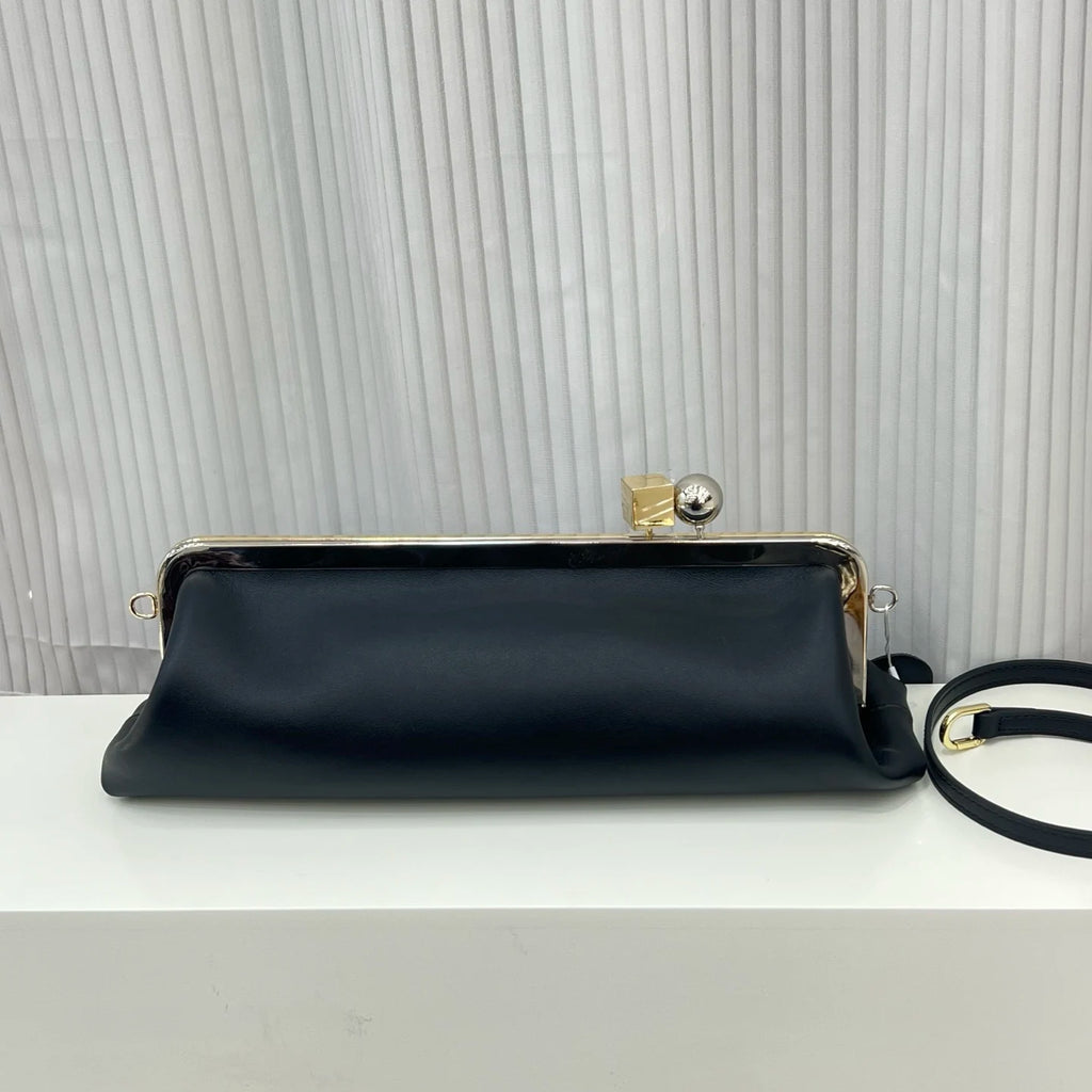 Black leather designer shoulder bag with a metal frame, geometric clasp, and detachable strap. Luxury clip handbag.