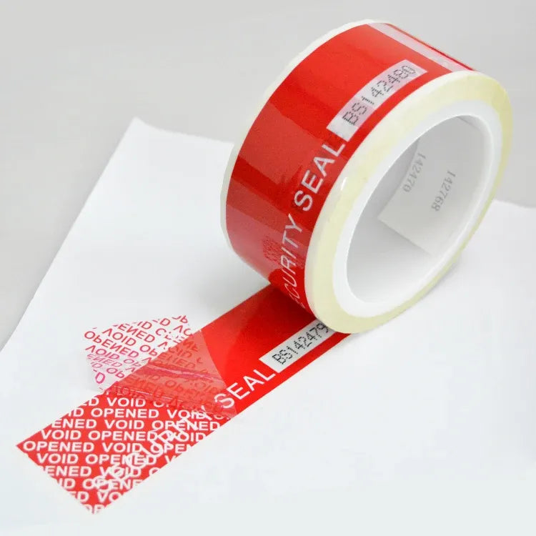 Red security seal void tape roll with printed tamper-evident VOID markings on release liner
