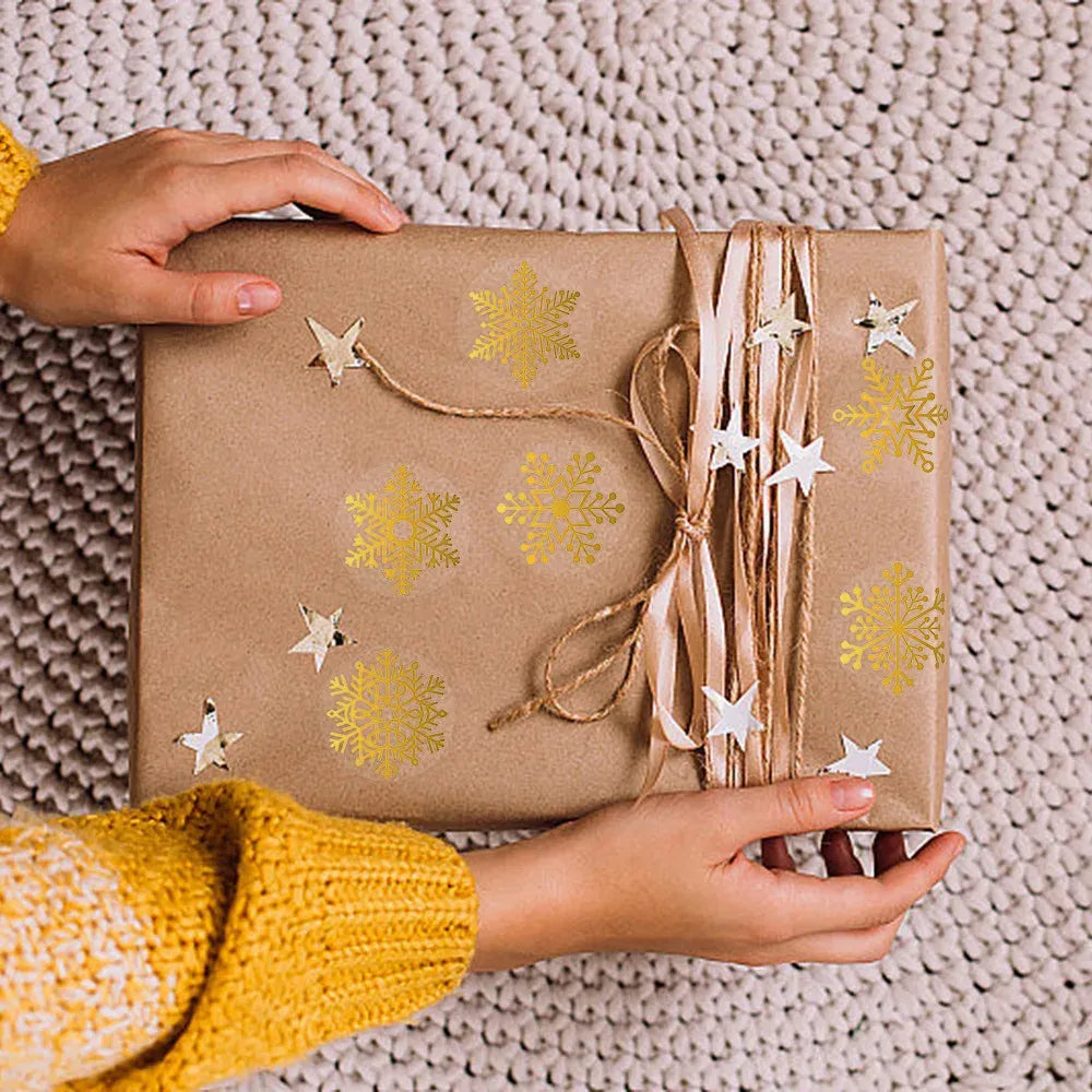 Gift box sealed with gold foil snowflake circle stickers