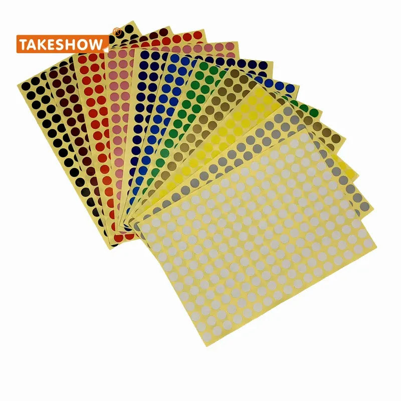 Assorted round dot sticker sheets in gold, brown, blue, and green tones