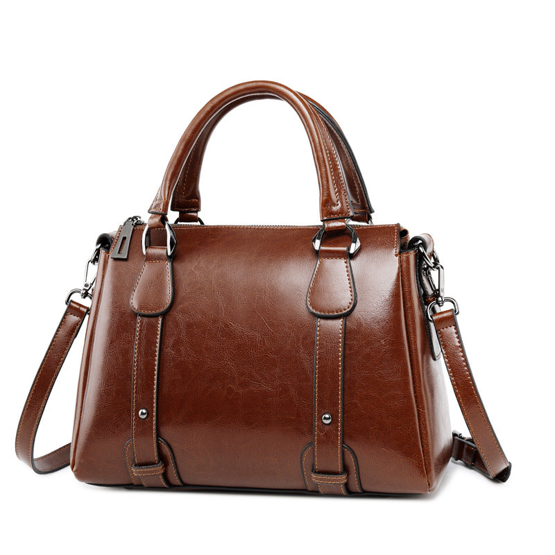 Brown genuine cow split leather top handle designer satchel tote handbag with adjustable shoulder strap and metal studs.
