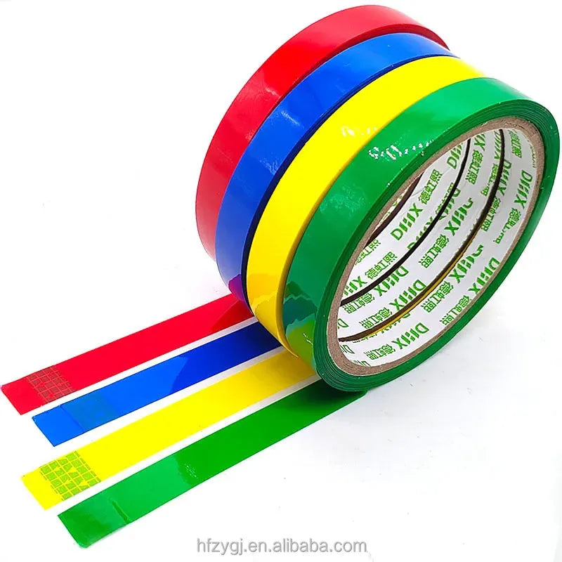 Colorful strapping tape rolls, glossy red blue green yellow with core showing print