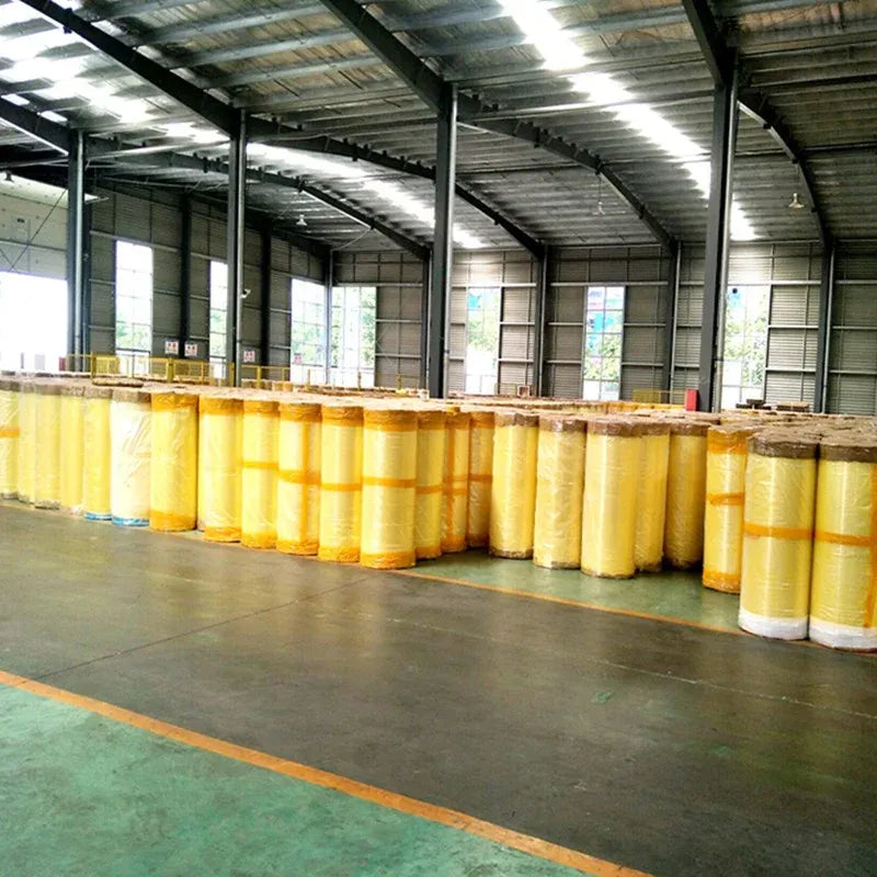 Clear BOPP packing tape jumbo rolls lined up on warehouse floor