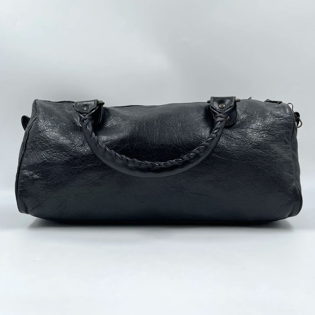 Black genuine leather pillow bag with braided handles, designer style, luxury second-hand tote.