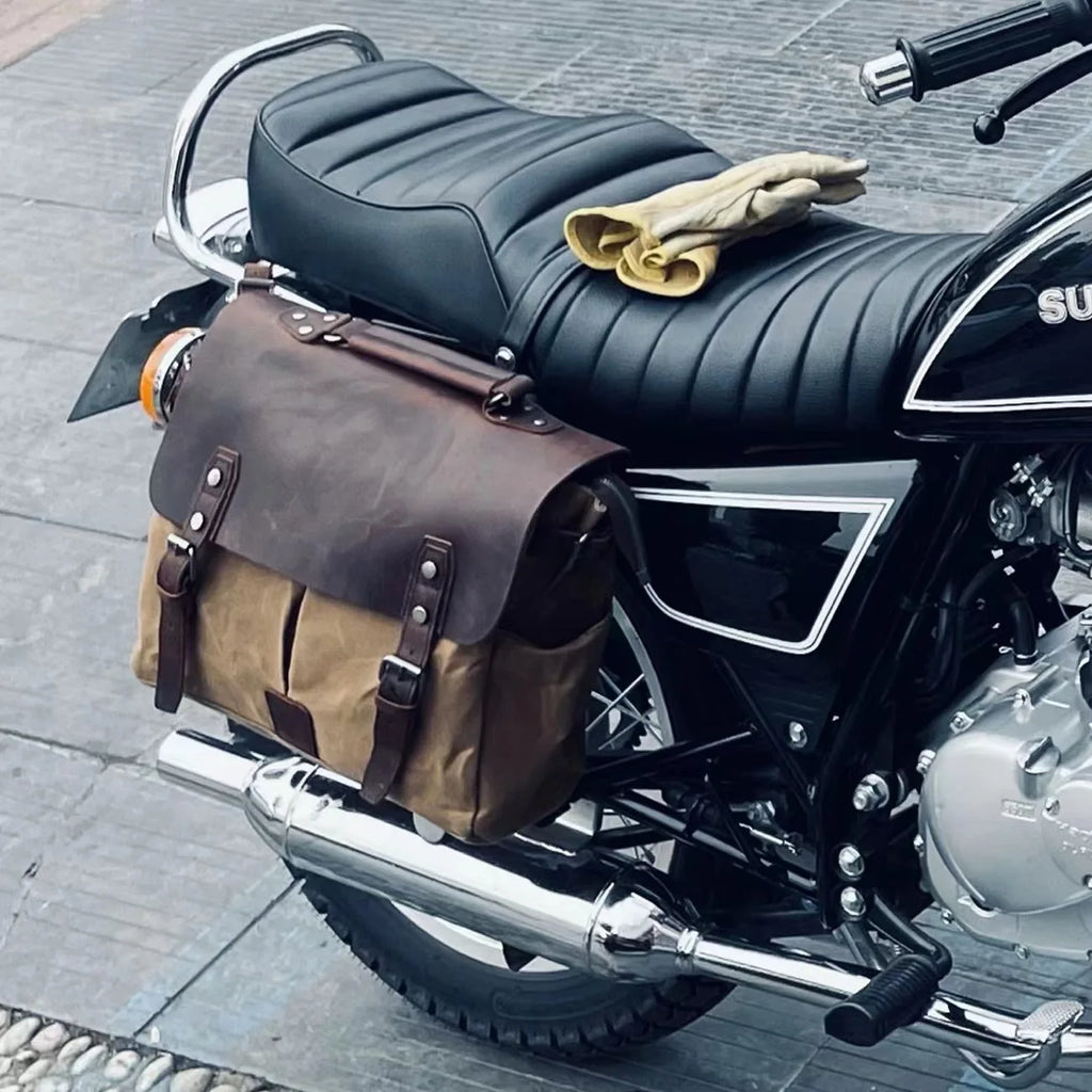 Retro waterproof motorcycle saddlebag in oil wax canvas and brown crazy horse leather with dual buckle straps.