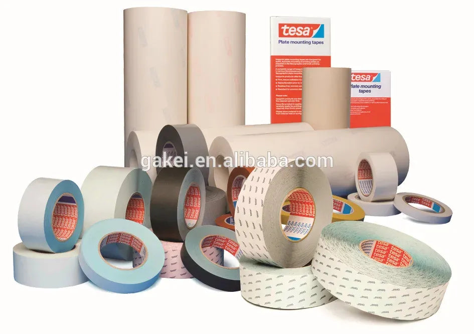 Assorted masking tape rolls, including white and gray, with tesa branding