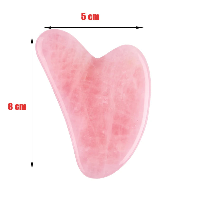 Heart-shaped light pink rose quartz gua sha tool, measuring 5cm wide by 8cm high on a white background.