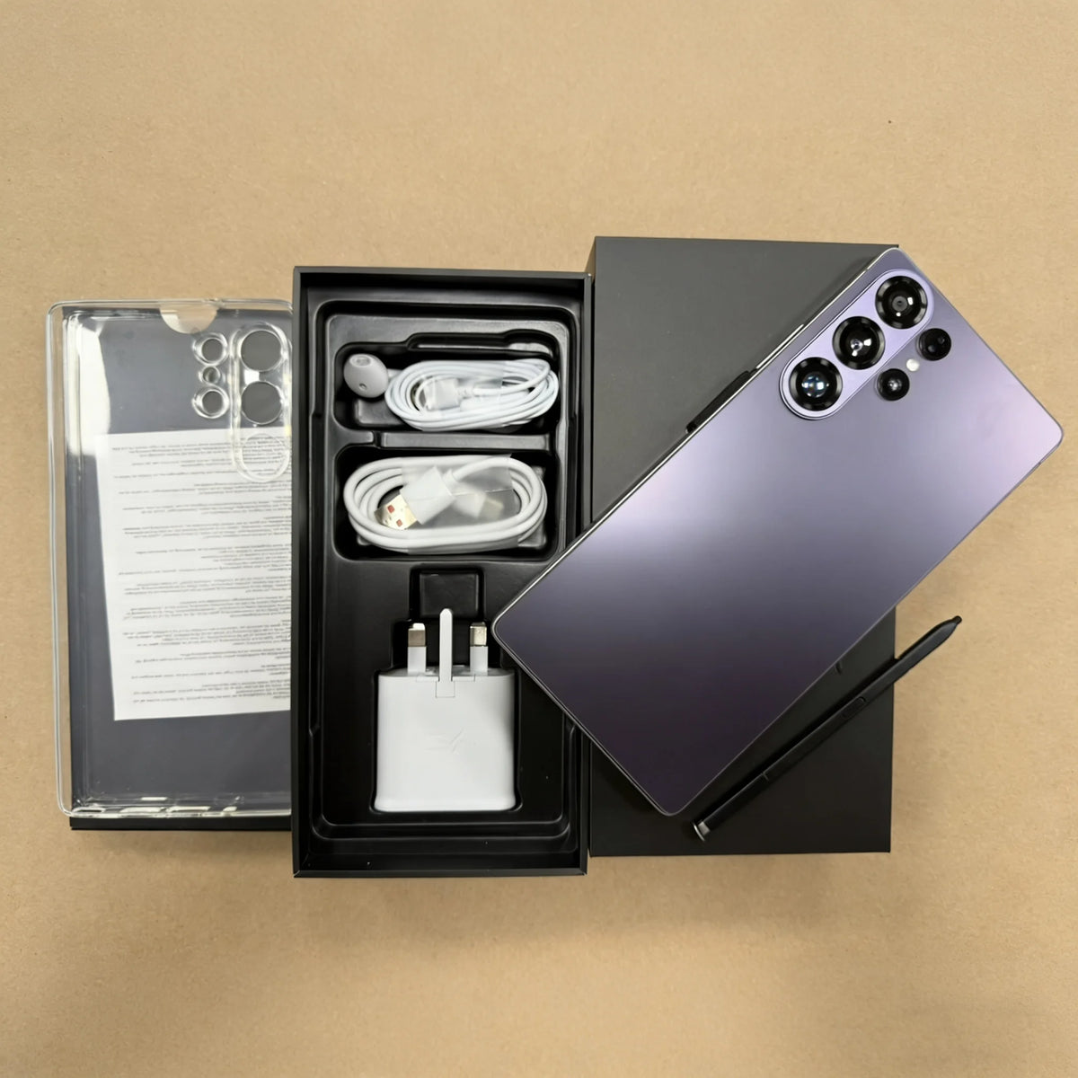 5G smartphone kit: phone with quad rear cameras, cable and charger adapter inside an open box.