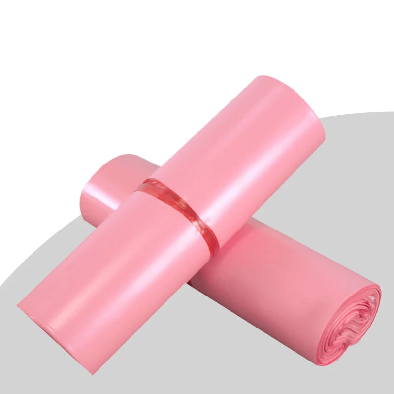 Pink poly mailer rolls wrapped together with red bands