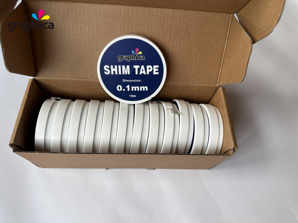 White shim tape rolls packed in a cardboard box