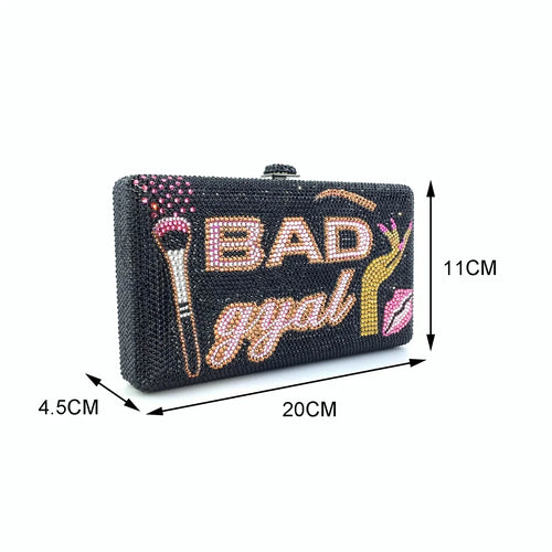 Black crystal rhinestone clutch with "BAD gyal" text, makeup brush, and lip art, ideal for evening glam events.