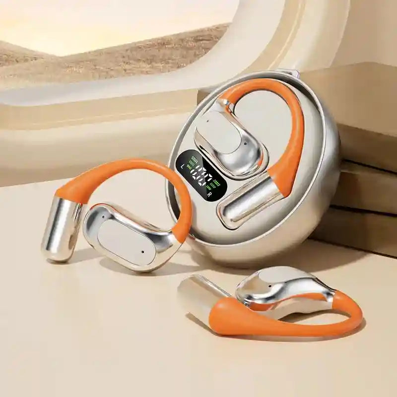 Silver and orange open-ear wireless earbuds with a round charging case featuring a digital battery display.