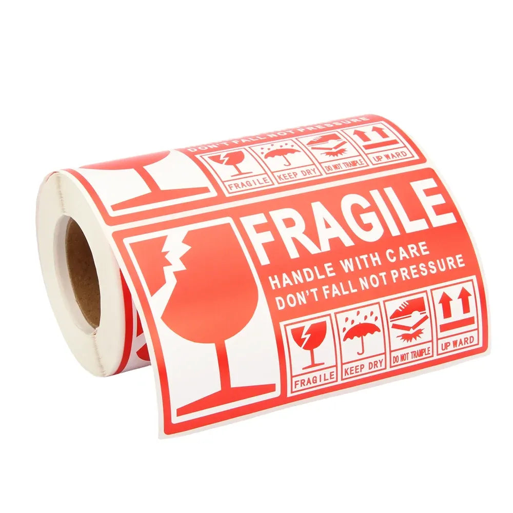 Rolled fragile handling label with red “FRAGILE” text and handle-with-care icons