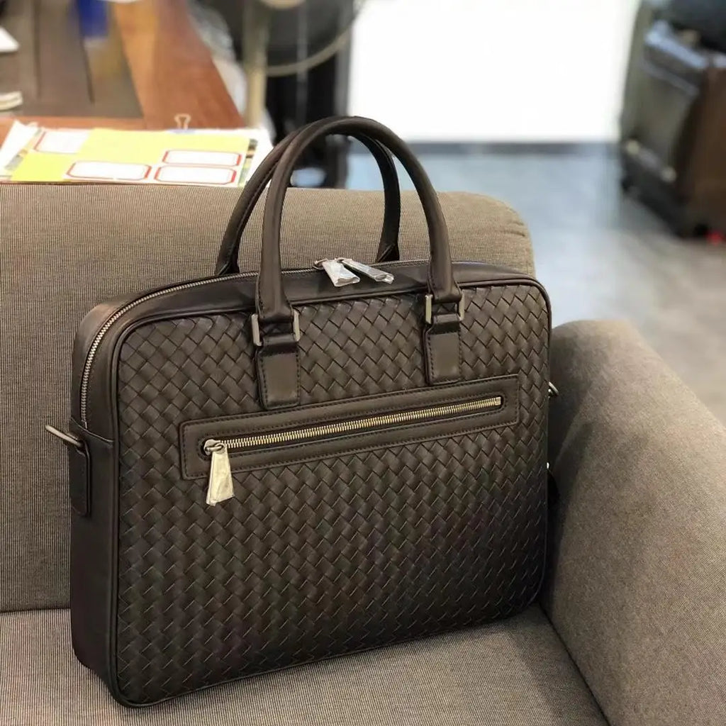 Luxury dark brown hand-woven leather 14-inch executive briefcase with top handles and exterior zip pocket.